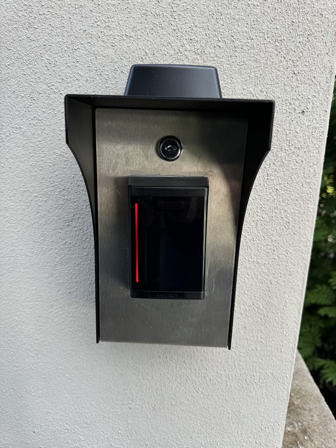 Access control reader installed at an exterior entry
