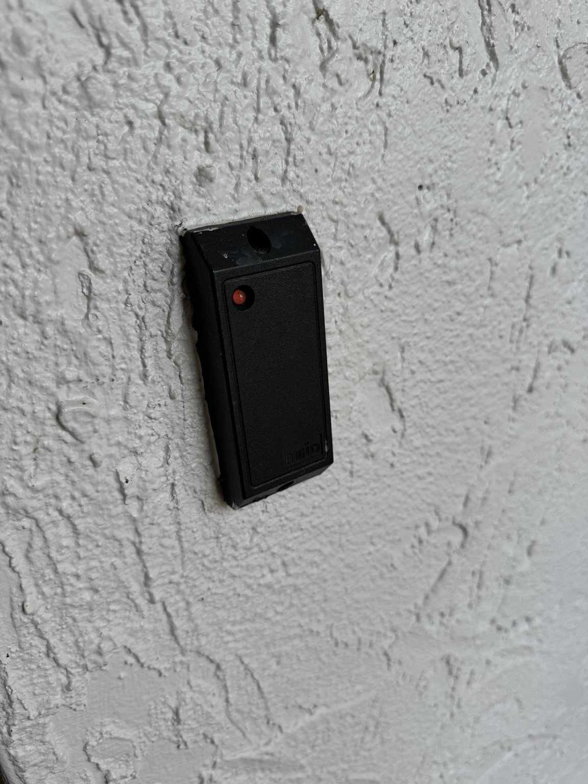 Credential reader installed on exterior wall