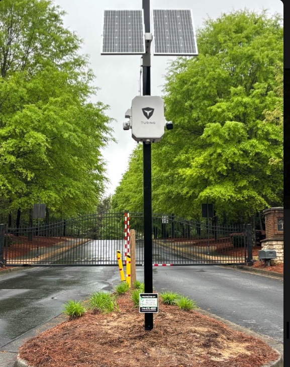 Turing SkyShield solar surveillance installation at a gated entrance